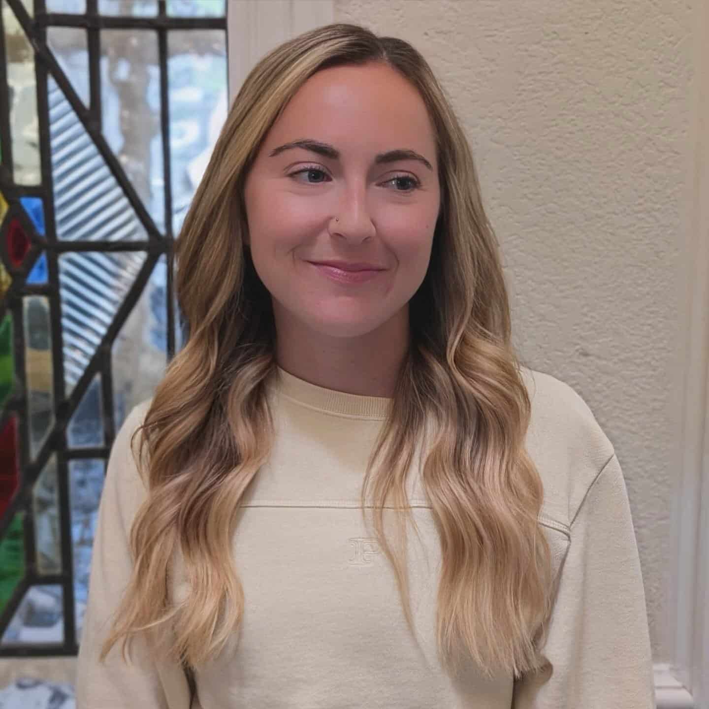 Long blonde waves after a colour refresh and new extensions by Haley at Fluff